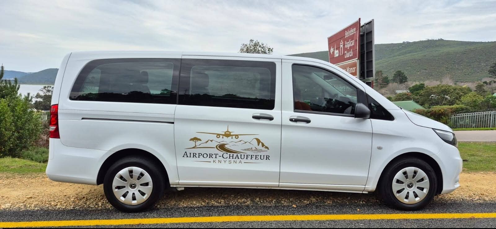 White Mercedes Vito chauffeur van from Airport-Chauffeur Knysna parked beside the Knysna lagoon on the Garden Route